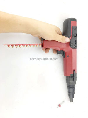 Pistolet à clous décoratif pour tapisseries rouges avec charges de poudre à bande et clous en béton durables